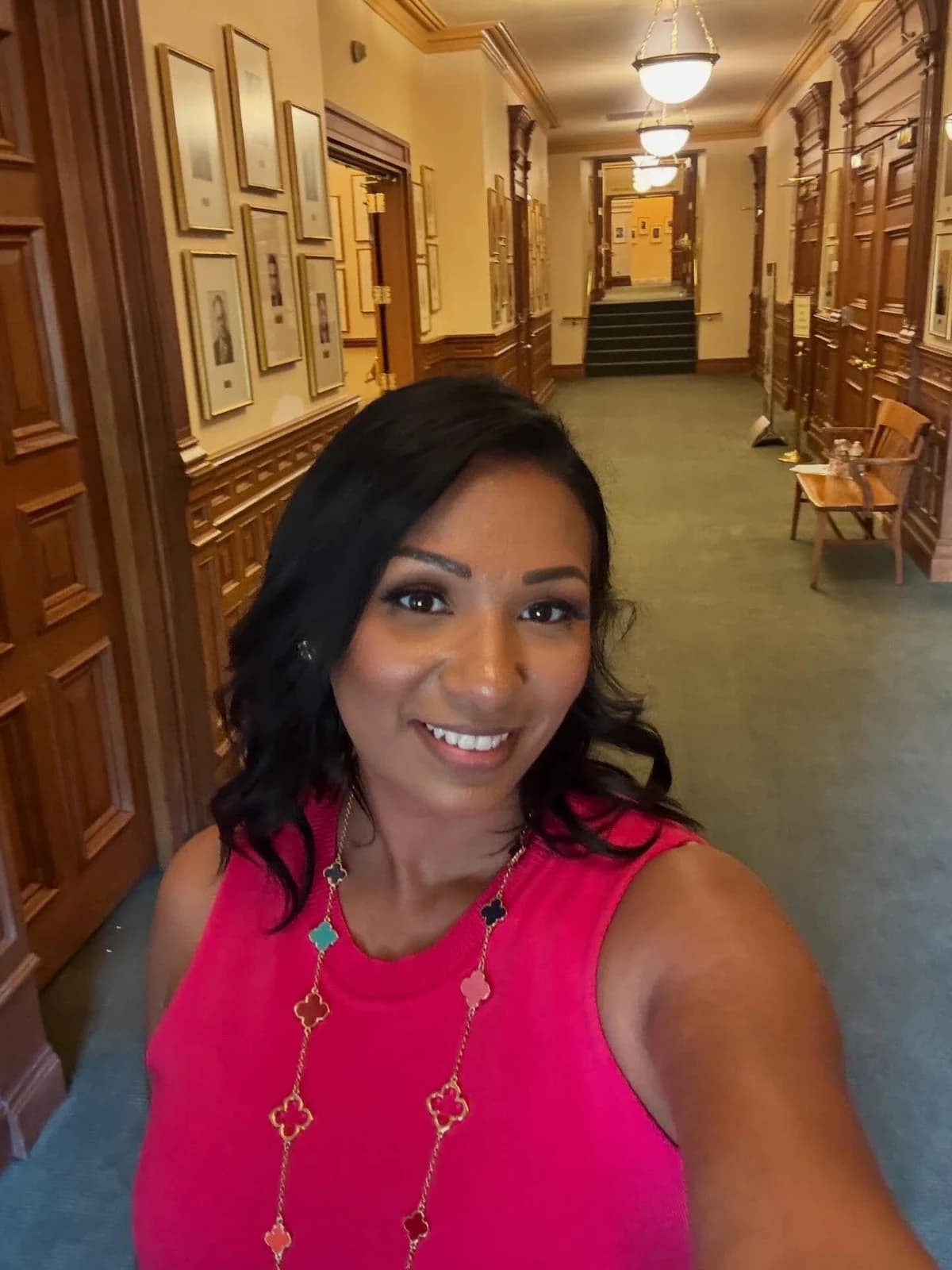 Assemblywoman Carmen Morales posing for a photograph in an indoor hallway