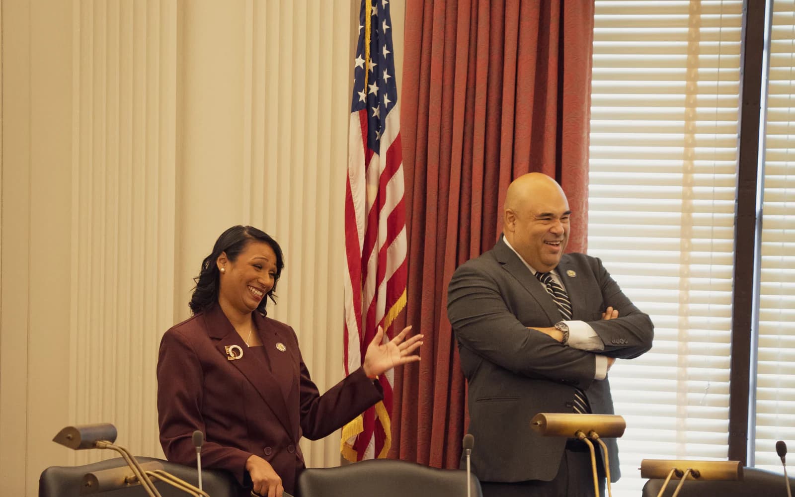 Assemblywoman Carmen Morales speaking with a legislative colleague in a State House committee room